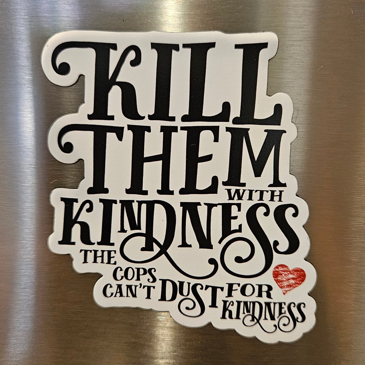 magnet with text 'Kill Them with Kindness' on a metallic surface