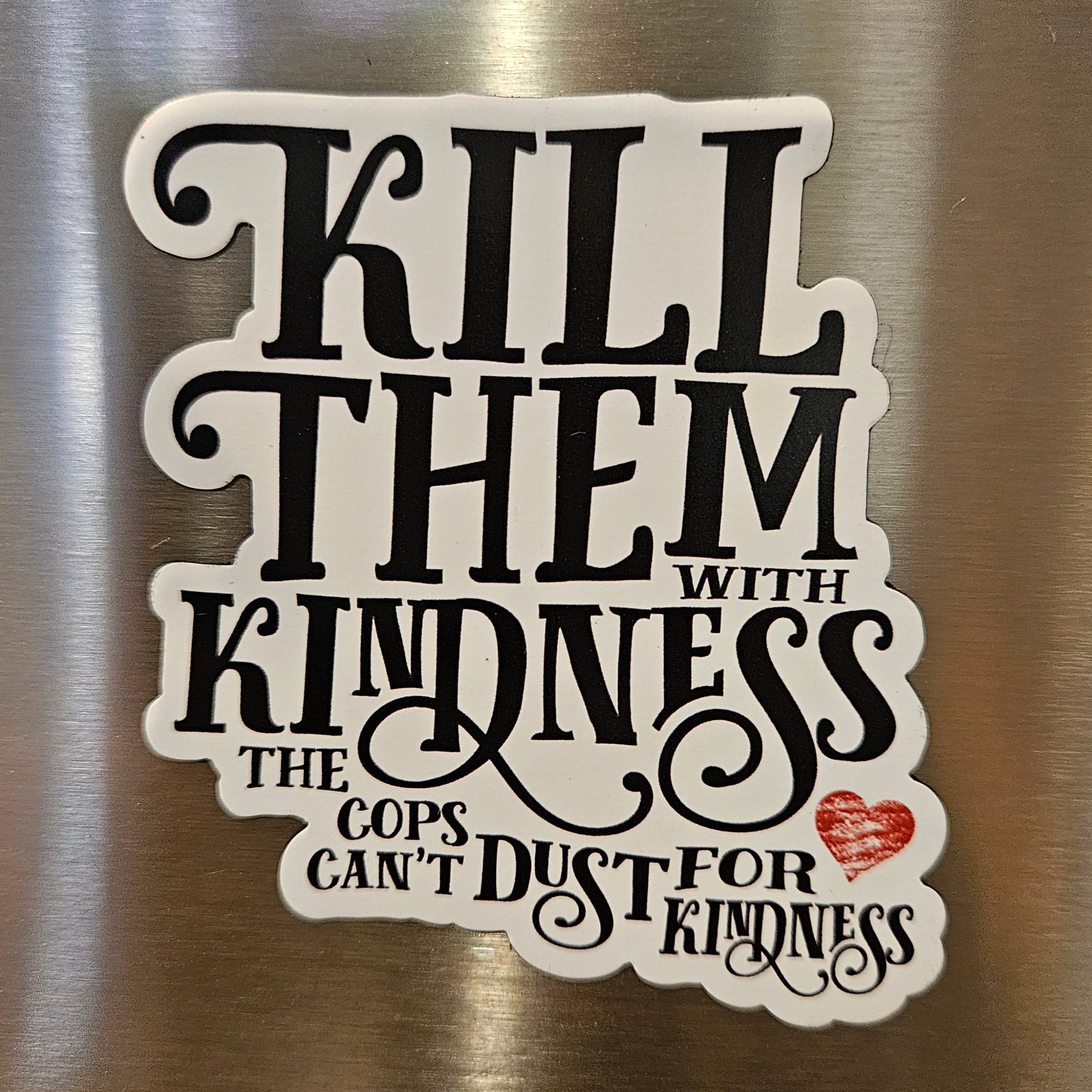magnet with text 'Kill Them with Kindness' on a metallic surface